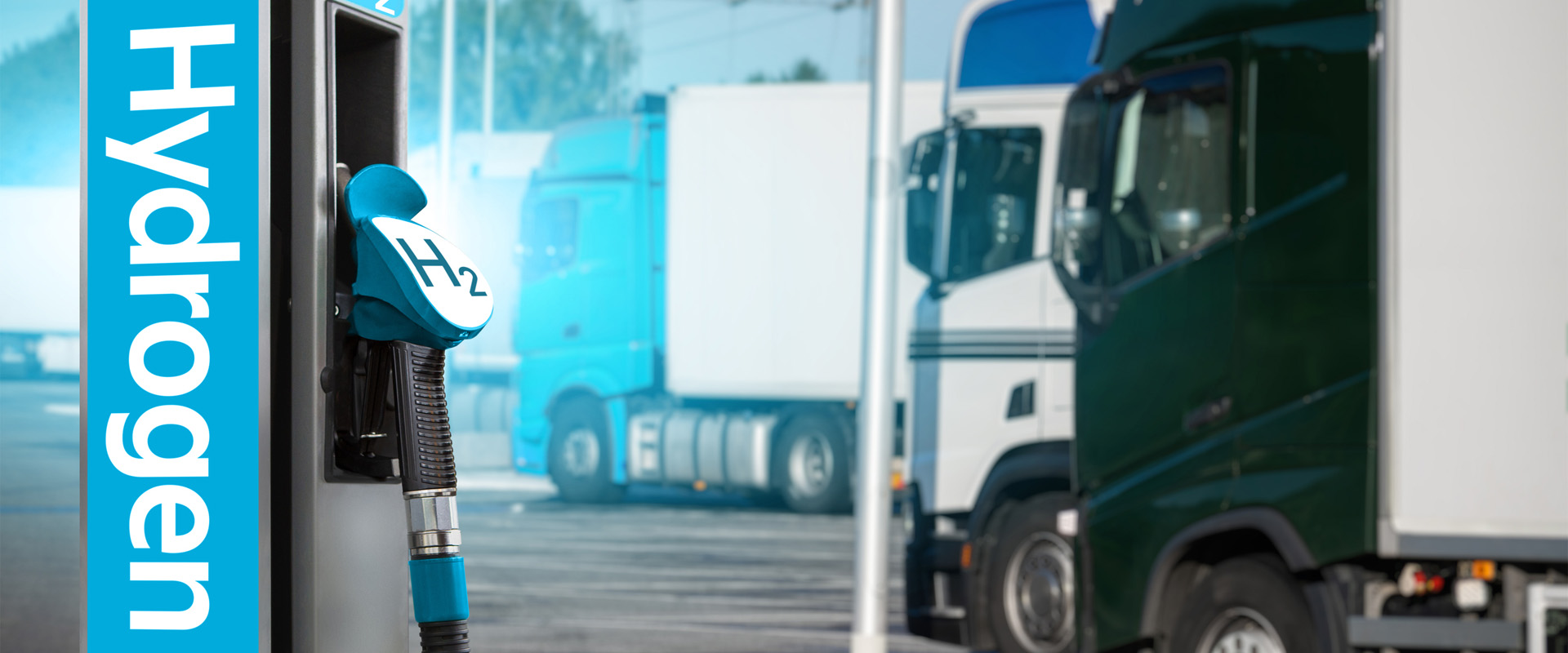 Hydrogen truck refueling station with trucks in the background.